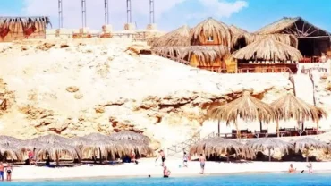 what is included in Mahmya Island tour - scenic boat approaching the island