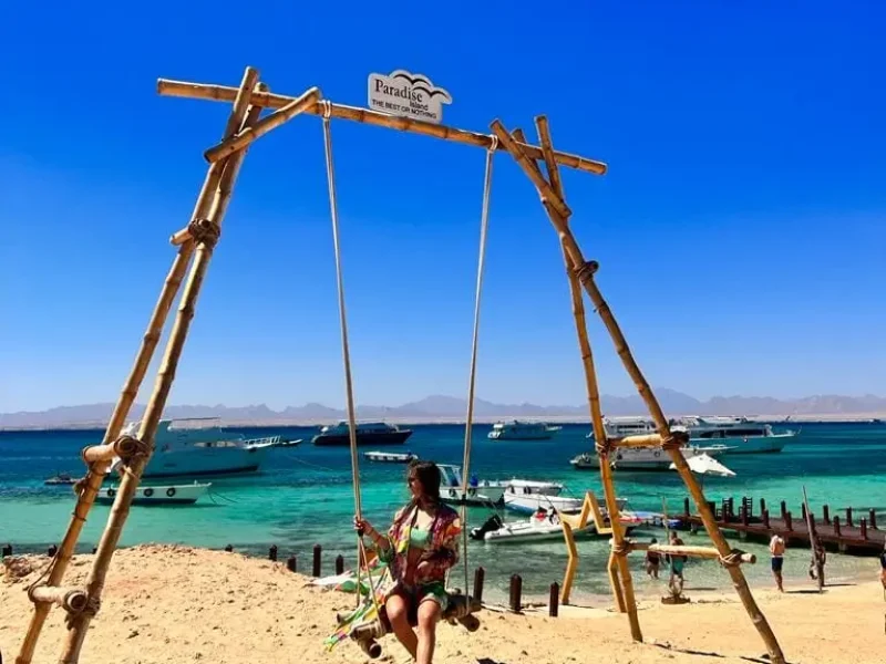 Paradise Island Hurghada price - A boat approaching the pristine shores of Paradise Island