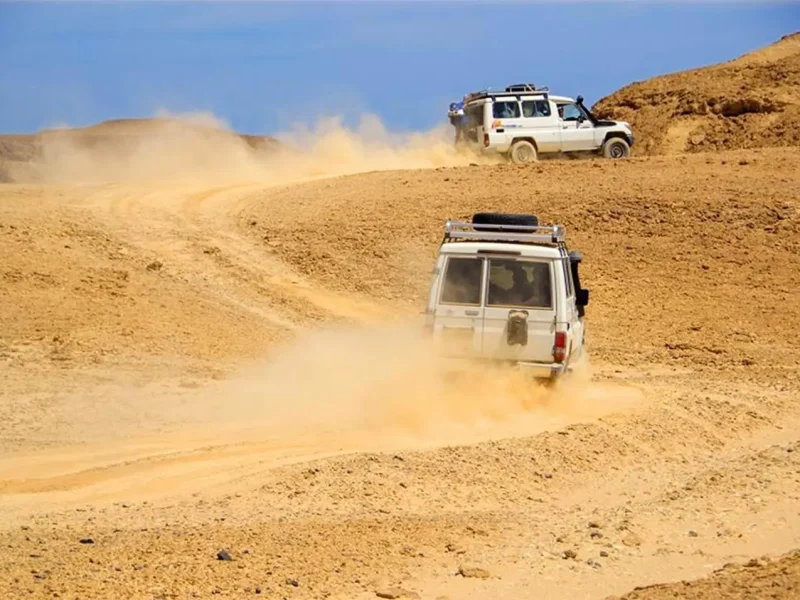 Hurghada jeep safari - a 4x4 vehicle driving through the desert at sunset