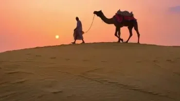 Bedouin village tour Hurghada - Group of tourists enjoying a camel ride in the desert